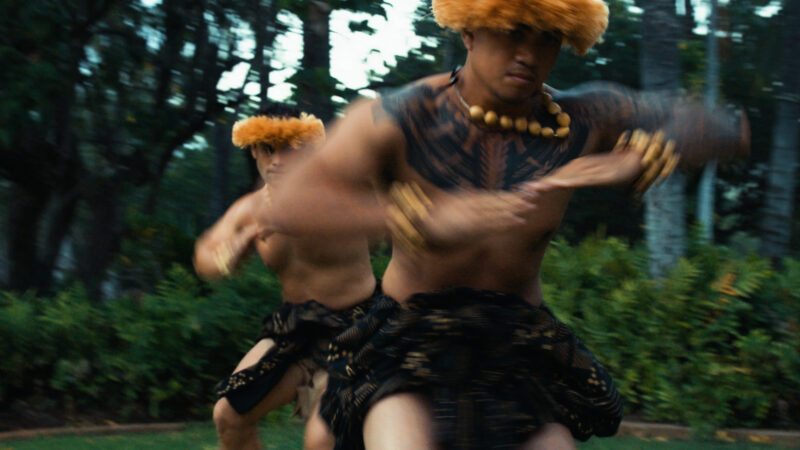 In Hawai‘i, cultural practice and connection to place are vital sources of community well-being and healing. When the pandemic reached the islands, the hula community fell silent for an entire year—no one danced. For the dancers in our film, that sudden stillness echoed earlier moments in Hawai‘i’s post-colonial era when hula was forced into dormancy, leaving behind a profound sense of cultural loss.
This scene, filmed more than a year into the pandemic, captures the men of Ke Kai O Kahiki as they return to their sacred practice space for the first time after that long, disorienting pause. (A teaser trailer follows.)
